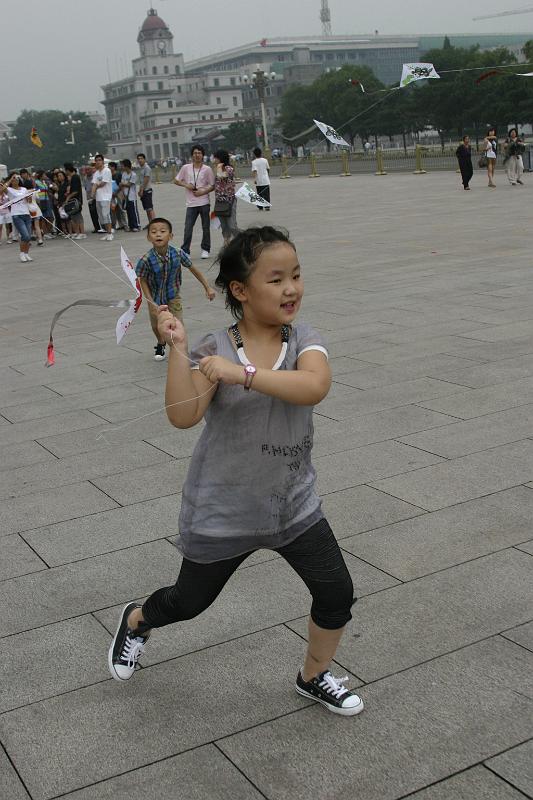 IMG_6781.JPG - A young girl flying a kit in Tiananmen Square.  Because of the history of the square (remember the guy facing down the tank?) there is pretty heavy plain clothes surveillance of the area.