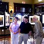 Janet Winter discusses a photo with two show attendees.