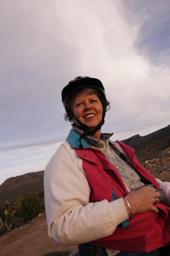 CRW_3716.JPG - Janet, at the stop on our sunset horse ride.  Sorry about the out-of-kilter horizon.  I had to twist around in the saddle and my butt hurt mightily.